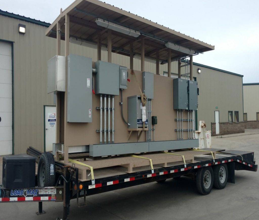 A large trailer truck with electrical boxes on it.