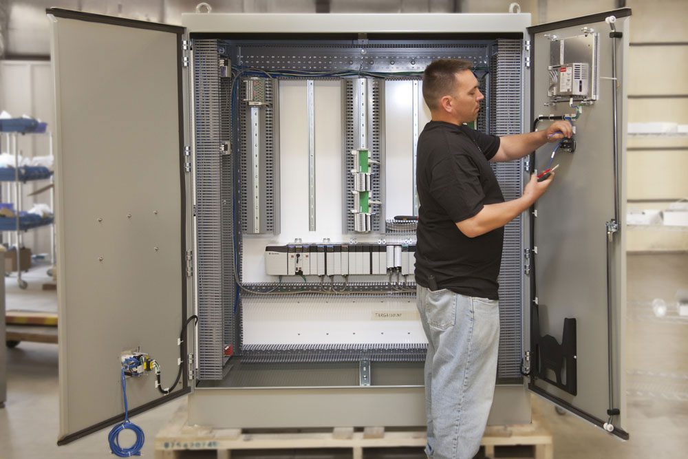 A man working on an electrical panel.