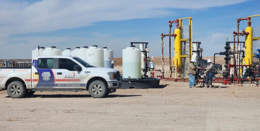 Oil and gas field crews working around production equipment during a job site safety operation