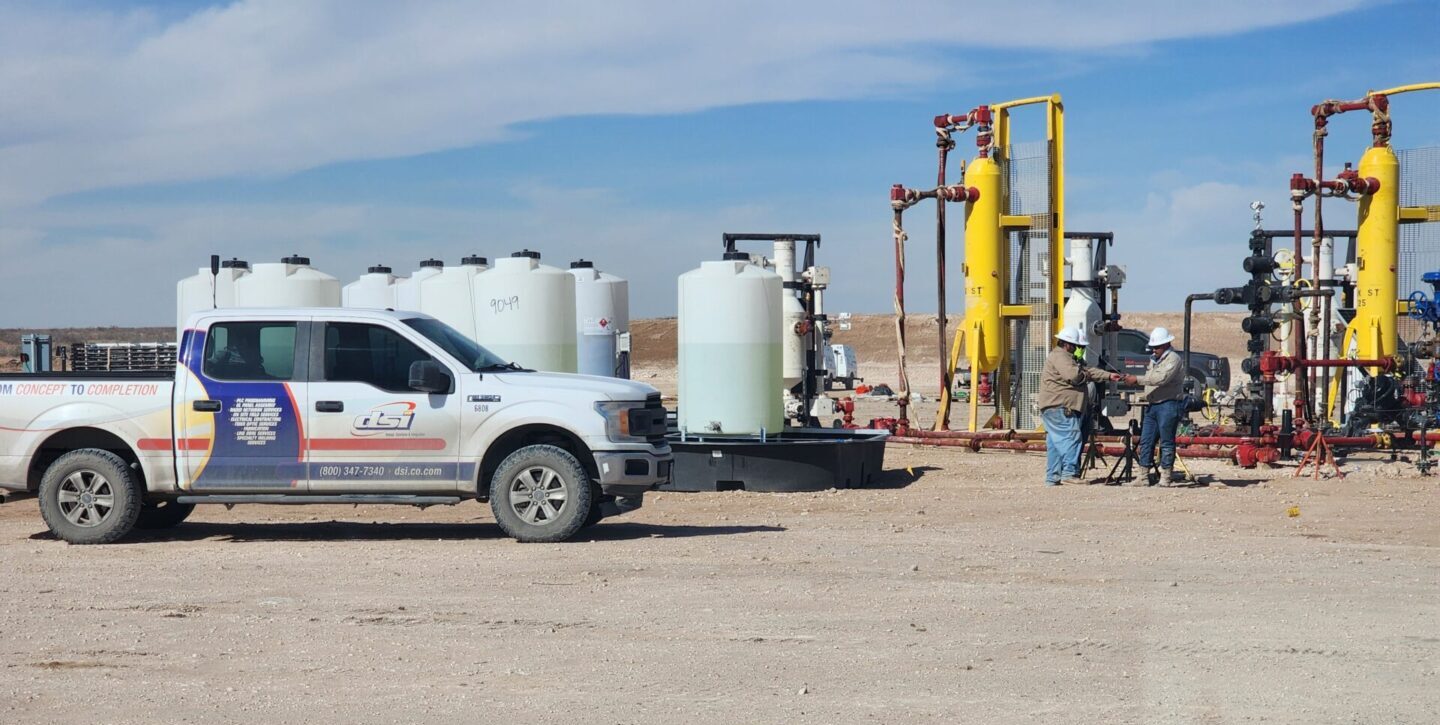 Oil and gas field crews working around production equipment during a job site safety operation