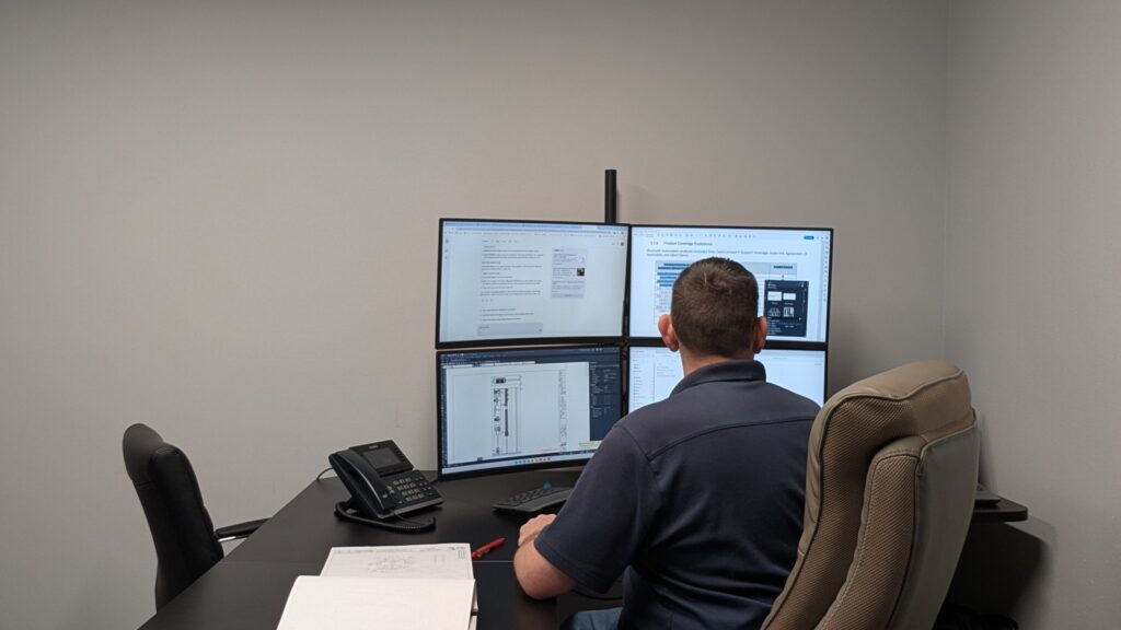 Automation engineer reviewing industrial control system design to reduce system integration risk