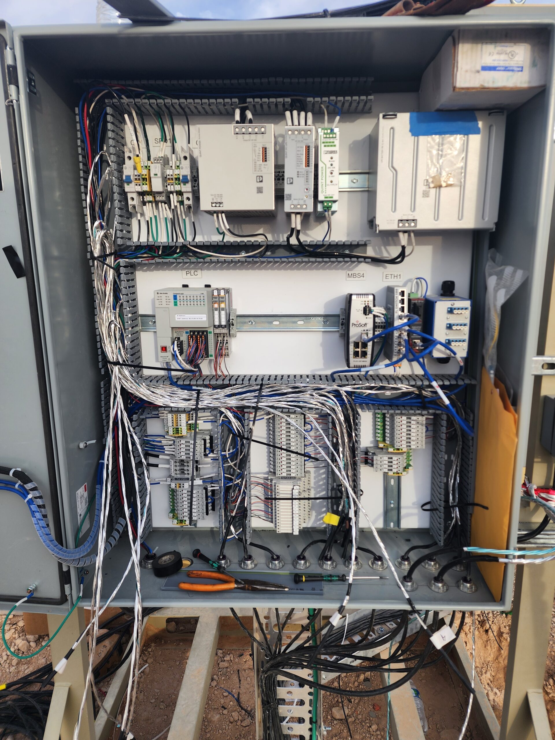 DSI-built UL508A oilfield control panel with PLC and terminal-block wiring