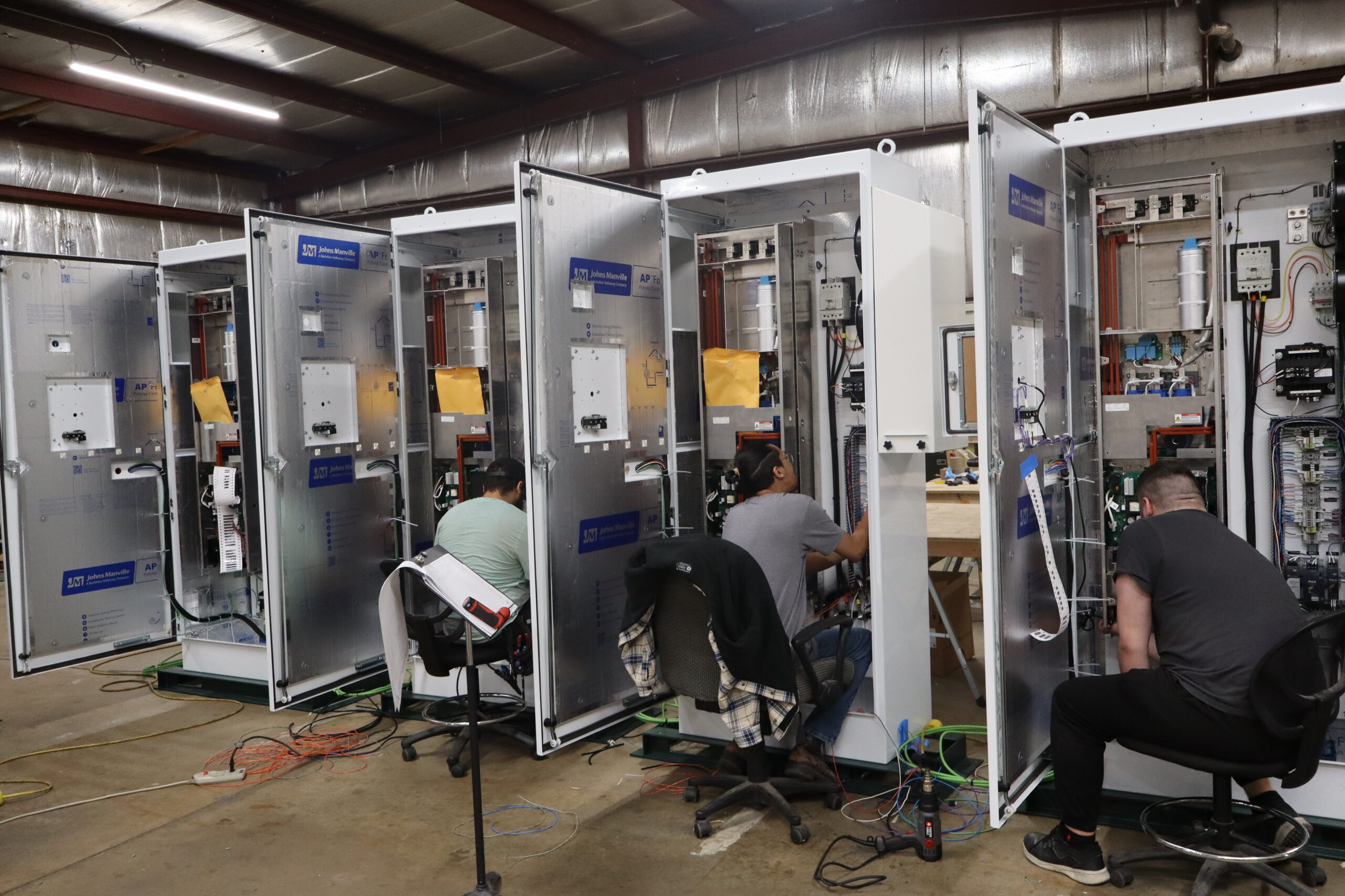 DSI employee-owners building control panels in the panel shop