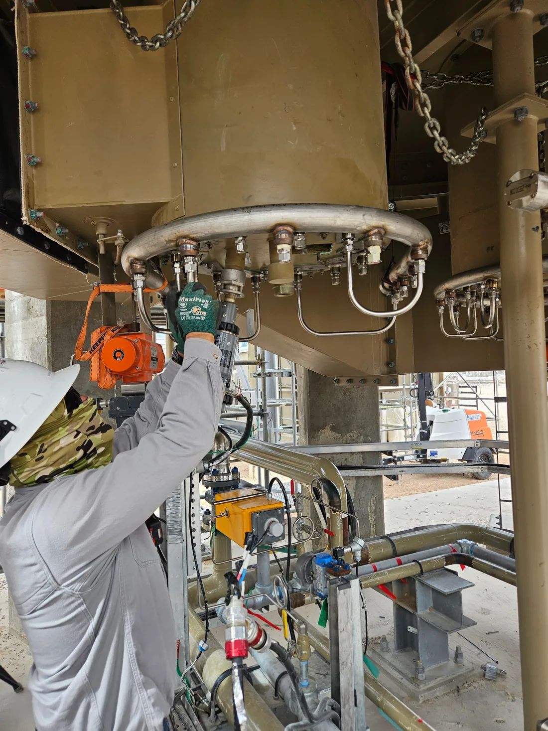 DSI electrical technician in PPE servicing field instrumentation at an oil and gas facility