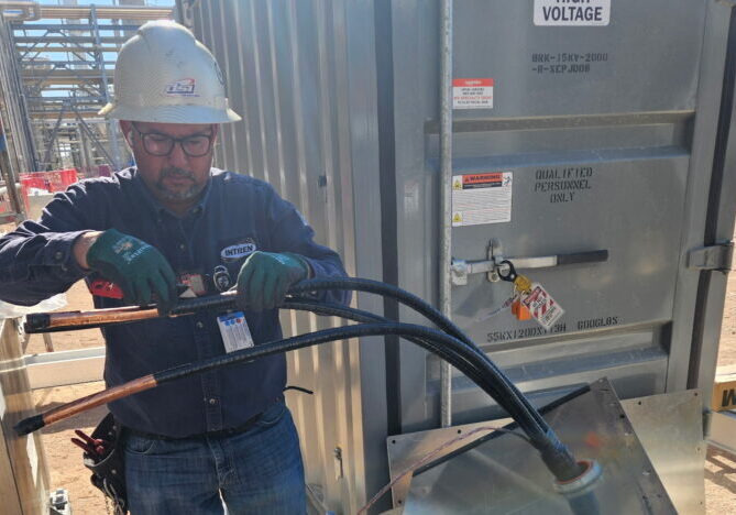 DSI electrician running conduit at a Class 1 Division 2 hazardous location oilfield site