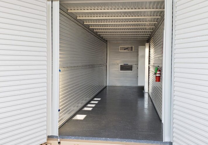 Shop-built shipping container fabricated for repeatable deployment across oil and gas projects