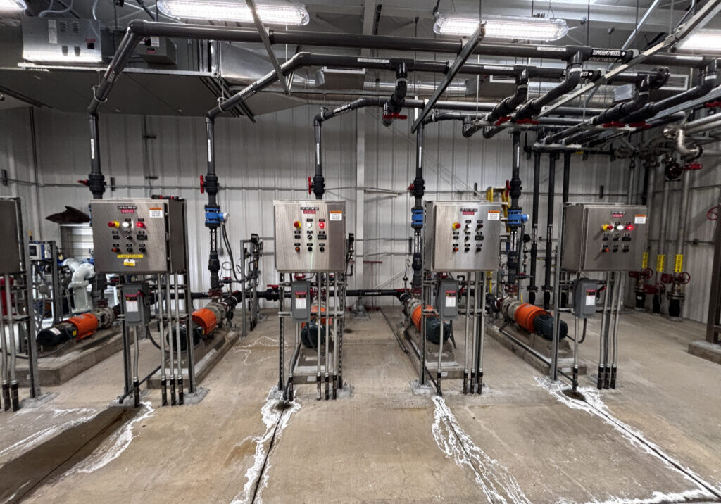 Pump station control panels and submersible pumps inside a municipal lift station